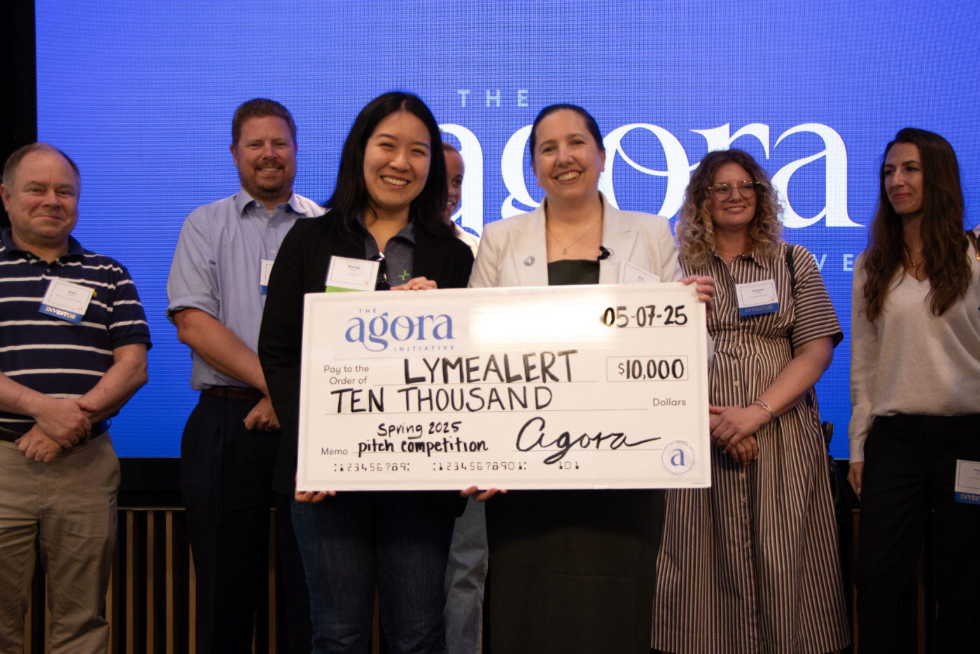 Winners on stage with a $10,000 grant check at the Venture Showcase